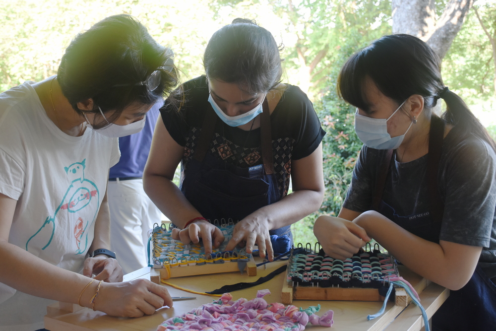 Smiha (centre) is helping Zhuang (left) to overcome some difficulties in her weaving. (Photo by Wong Siew Kuen)  