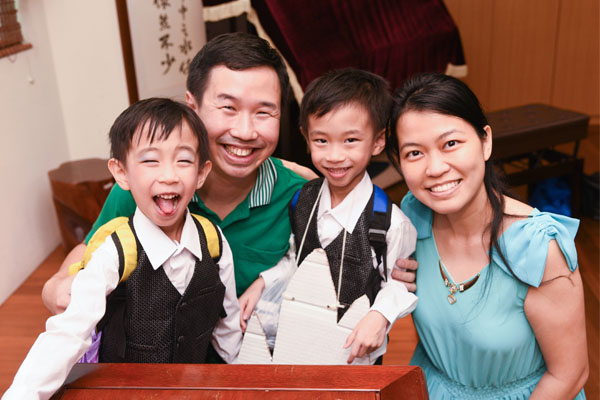 Twins Wei Zhen and Wei Zhang often remind their parents of earth-friendly practices, such as saving on resource consumption. (Photo by Wong Twee Hee)